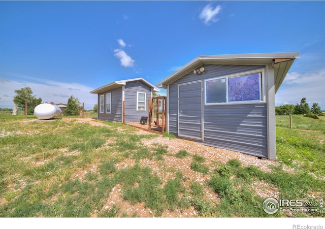 34427 County Rd W, Hillrose, CO 80733 - rear view of house featuring an outbuilding