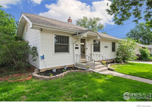 1417 14th St, Greeley, CO 80631 - view of front of property featuring a front lawn and a chimney