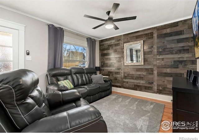 1417 14th St, Greeley, CO 80631 - living area with wooden walls, ornamental molding, a ceiling fan, and wood finished floors