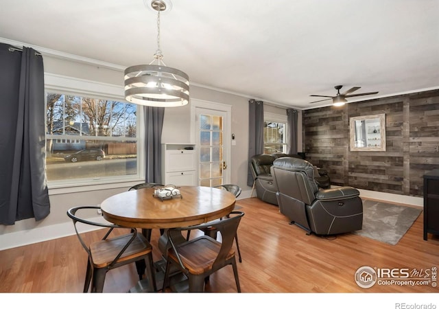 1417 14th St, Greeley, CO 80631 - dining area with wood walls, a chandelier, healthy amount of natural light, light wood-style flooring, and ornamental molding