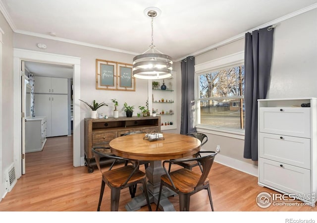 1417 14th St, Greeley, CO 80631 - dining room featuring light wood-style floors, a chandelier, and crown molding