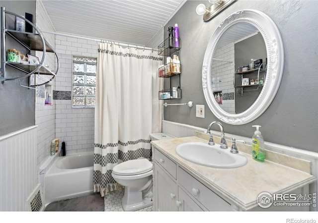 1417 14th St, Greeley, CO 80631 - full bathroom featuring vanity, shower / tub combo, wainscoting, and tile patterned floors