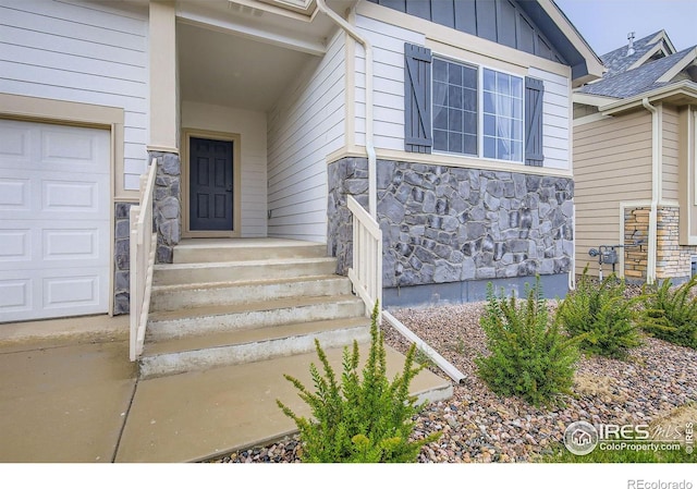 825 Forest Canyon Rd, Severance, CO 80550 - property entrance featuring stone siding, a garage, and board and batten siding