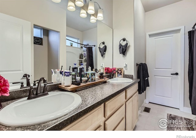 825 Forest Canyon Rd, Severance, CO 80550 - full bath with double vanity, tile patterned flooring, curtained shower, and a chandelier