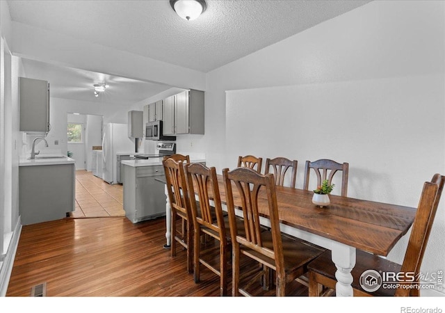 3421 Surrey Ln, Fort Collins, CO 80524 - dining space with light wood-type flooring, a textured ceiling, and a ceiling fan
