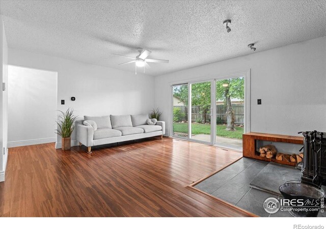 3421 Surrey Ln, Fort Collins, CO 80524 - living room with wood finished floors, ceiling fan, and a textured ceiling