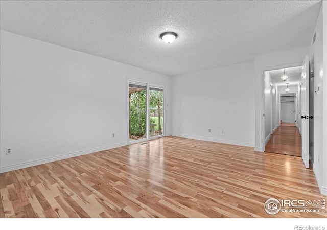 3421 Surrey Ln, Fort Collins, CO 80524 - empty room with a textured ceiling and light wood-style flooring