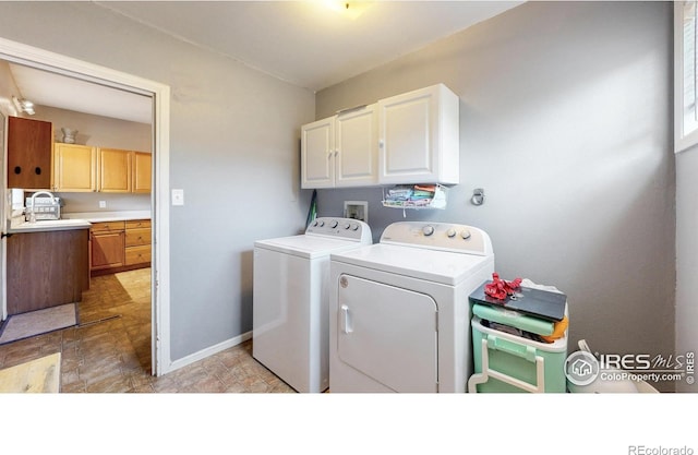 143 W 10th St, Loveland, CO 80537 - washroom featuring cabinet space and washing machine and dryer
