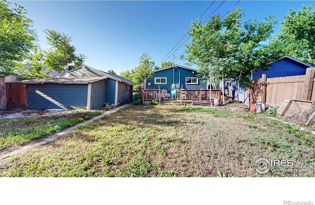 143 W 10th St, Loveland, CO 80537 - view of yard with a wooden deck and an outbuilding