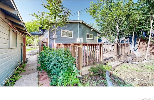 143 W 10th St, Loveland, CO 80537 - view of side of home featuring a deck