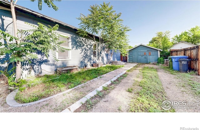 143 W 10th St, Loveland, CO 80537 - view of home's exterior with dirt driveway, a shed, and entry steps
