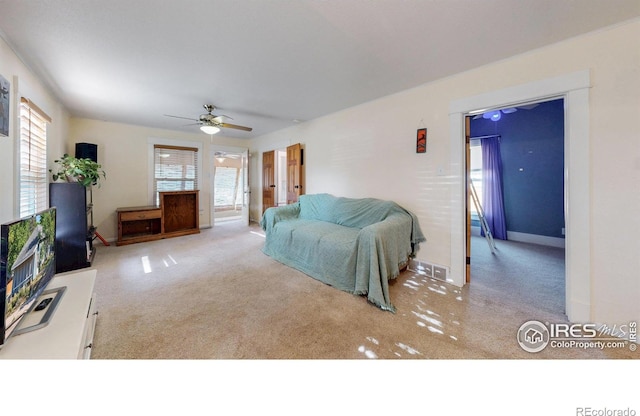 143 W 10th St, Loveland, CO 80537 - carpeted living area with a ceiling fan and baseboards