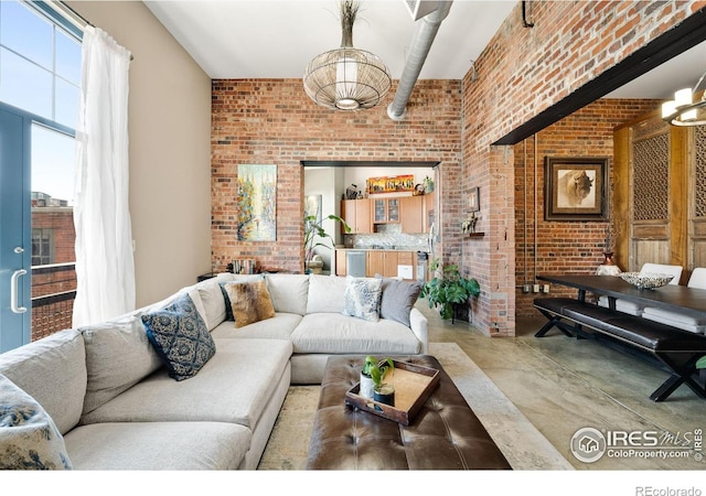 2500 Walnut St Unit 201, Denver, CO 80205 - living room featuring brick wall and concrete floors