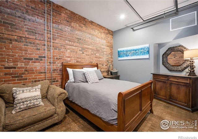 2500 Walnut St Unit 201, Denver, CO 80205 - bedroom featuring brick wall and recessed lighting