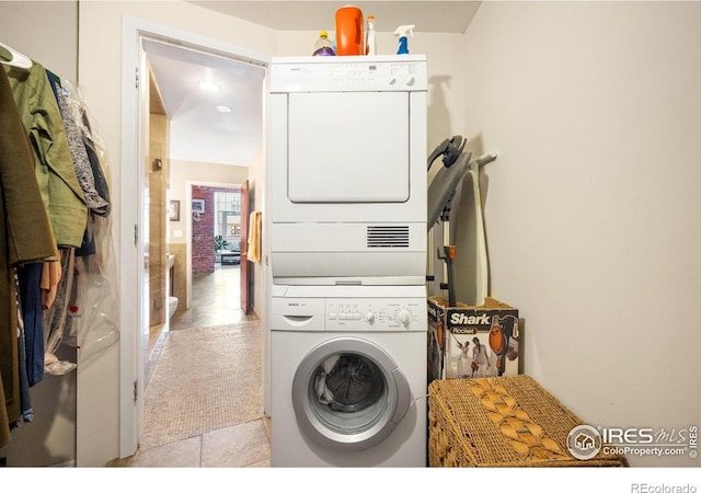 2500 Walnut St Unit 201, Denver, CO 80205 - laundry area with stacked washer / drying machine and light tile patterned flooring