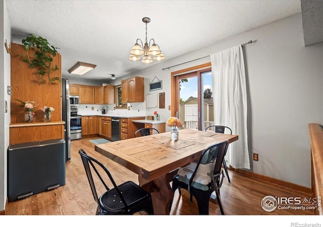 4324 W 22nd St, Greeley, CO 80634 - dining area with light wood-style floors and a chandelier