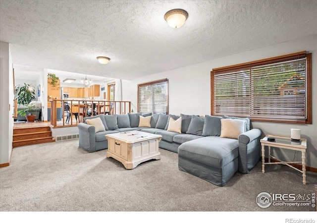 4324 W 22nd St, Greeley, CO 80634 - living area featuring a chandelier, carpet floors, and a textured ceiling