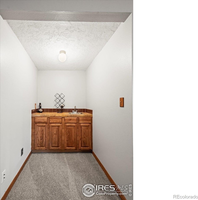 4324 W 22nd St, Greeley, CO 80634 - indoor wet bar with light colored carpet and a textured ceiling