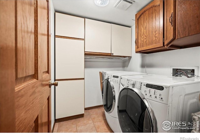 4324 W 22nd St, Greeley, CO 80634 - laundry area with cabinet space, separate washer and dryer, and light tile patterned flooring