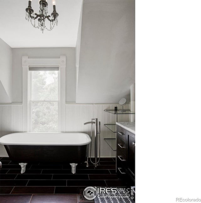 505 Pine St, Boulder, CO 80302 - bathroom with wainscoting, a chandelier, vanity, a freestanding bath, and wood finish floors