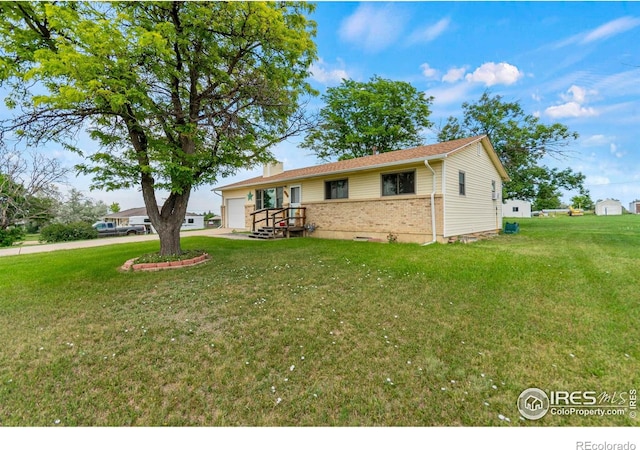 2110 Charro Ave, Longmont, CO 80504 - view of front of property with a garage, a front yard, brick siding, and a chimney