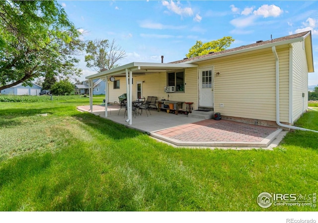 2110 Charro Ave, Longmont, CO 80504 - rear view of property featuring a patio area, a yard, and entry steps
