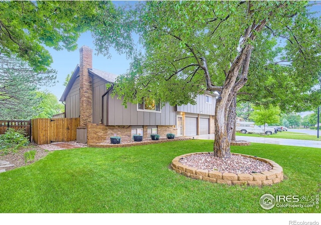 2912 Worthington Ave, Fort Collins, CO 80526 - view of front of home with a chimney, brick siding, concrete driveway, board and batten siding, and an attached garage