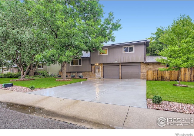 2912 Worthington Ave, Fort Collins, CO 80526 - tri-level home with a garage, driveway, and brick siding