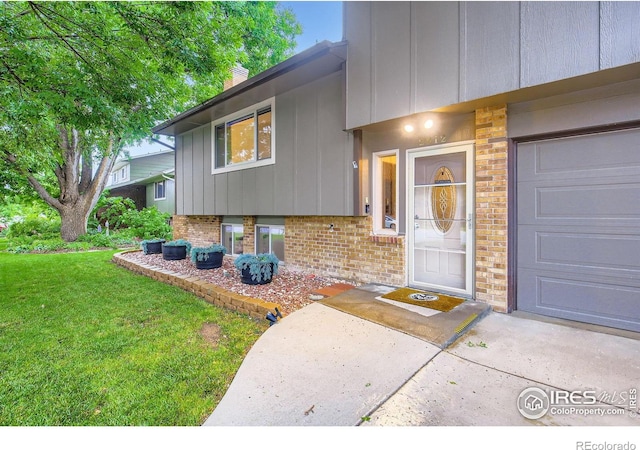 2912 Worthington Ave, Fort Collins, CO 80526 - view of exterior entry featuring brick siding, a yard, a chimney, and board and batten siding