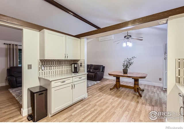 2912 Worthington Ave, Fort Collins, CO 80526 - kitchen featuring beamed ceiling, light countertops, light wood-style floors, a ceiling fan, and white cabinetry