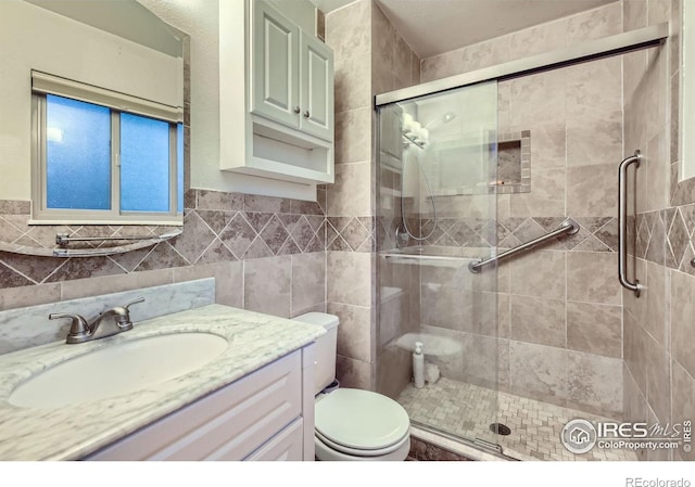 2912 Worthington Ave, Fort Collins, CO 80526 - bathroom featuring a stall shower, vanity, and tile walls