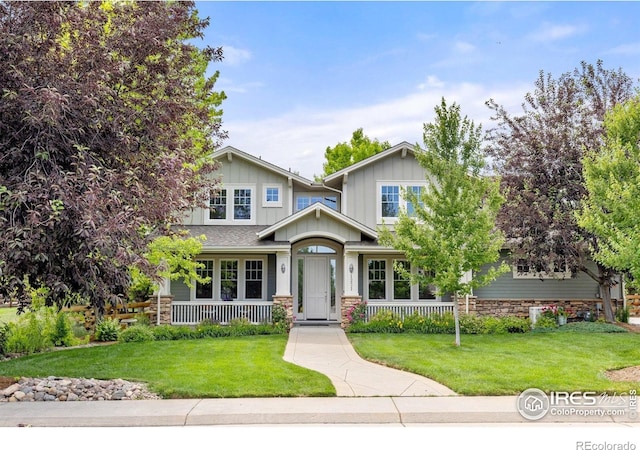 1231 Hawk Ridge Rd, Lafayette, CO 80026 - craftsman inspired home featuring covered porch, a front yard, board and batten siding, and stone siding