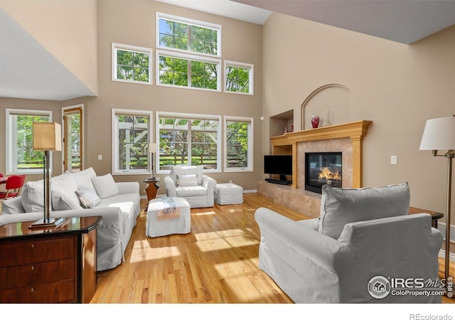 1231 Hawk Ridge Rd, Lafayette, CO 80026 - living room with wood finished floors, a high end fireplace, and a high ceiling