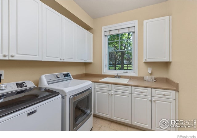 1231 Hawk Ridge Rd, Lafayette, CO 80026 - laundry room featuring separate washer and dryer, cabinet space, and light tile patterned flooring