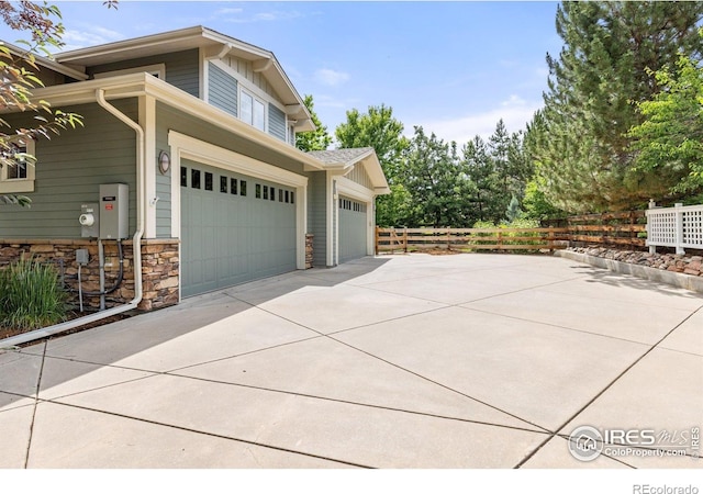 1231 Hawk Ridge Rd, Lafayette, CO 80026 - view of side of home with concrete driveway and stone siding