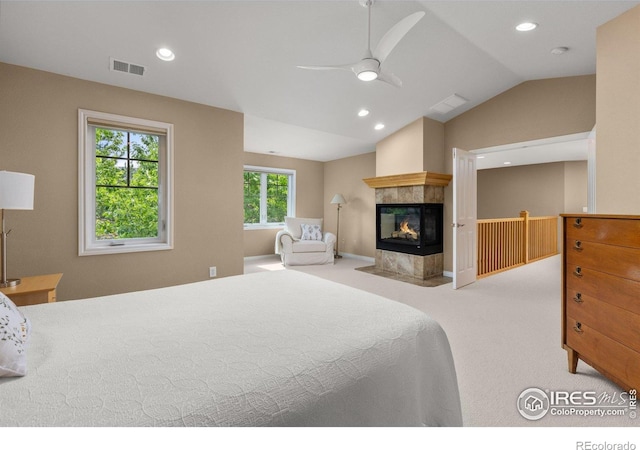 1231 Hawk Ridge Rd, Lafayette, CO 80026 - carpeted bedroom featuring lofted ceiling, recessed lighting, a tile fireplace, and a ceiling fan