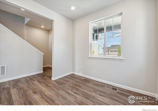 850 Mesic Ln, Windsor, CO 80550 - empty room featuring wood finished floors, stairs, and recessed lighting