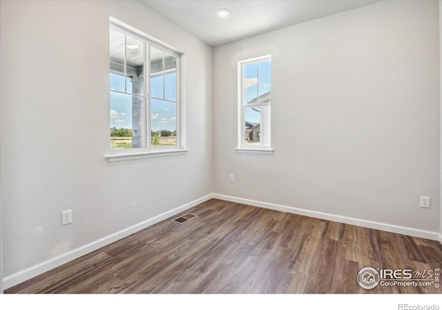850 Mesic Ln, Windsor, CO 80550 - empty room featuring plenty of natural light and dark wood-style floors
