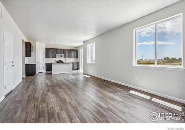 850 Mesic Ln, Windsor, CO 80550 - unfurnished living room featuring dark wood-style flooring and recessed lighting