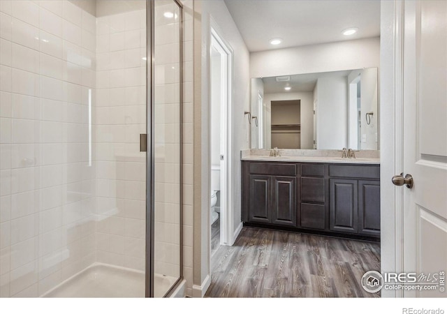 850 Mesic Ln, Windsor, CO 80550 - full bath with a stall shower, wood finished floors, double vanity, and recessed lighting