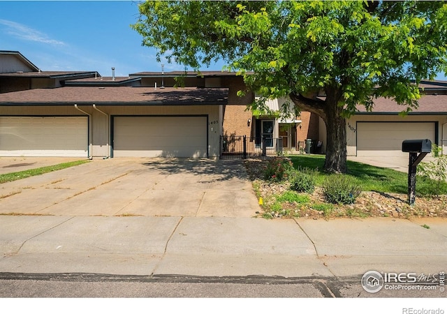 1405 S 11th Ave, Sterling, CO 80751 - mid-century inspired home with driveway, an attached garage, and stucco siding