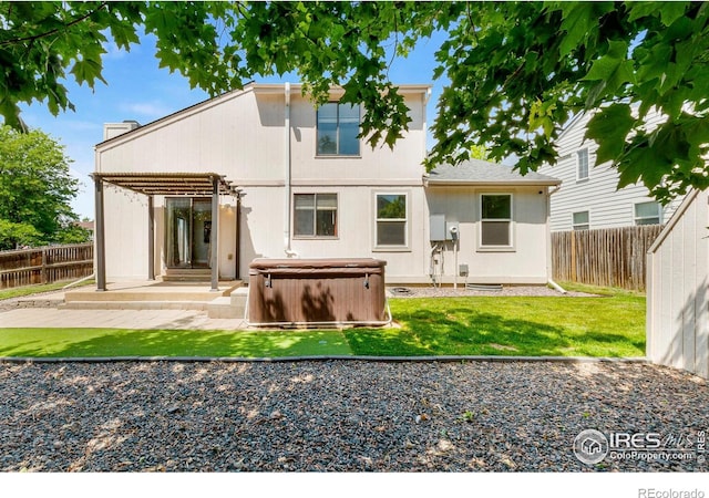 7414 Benton St, Arvada, CO 80003 - rear view of house featuring a hot tub, a patio area, and a fenced backyard
