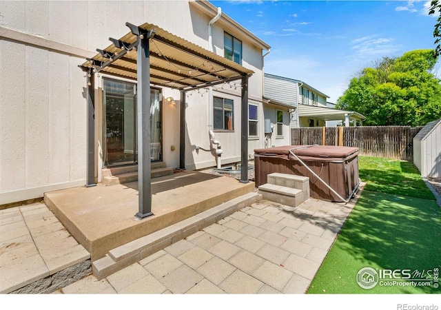 7414 Benton St, Arvada, CO 80003 - fenced backyard with a hot tub, a patio, entry steps, and a pergola