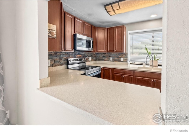 7414 Benton St, Arvada, CO 80003 - kitchen with appliances with stainless steel finishes, decorative backsplash, light countertops, and brown cabinetry