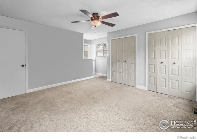 7414 Benton St, Arvada, CO 80003 - unfurnished bedroom with multiple closets, carpet, and ceiling fan