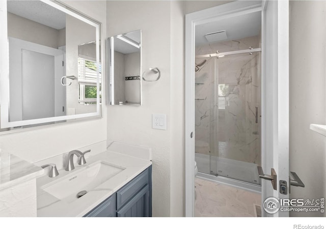 7414 Benton St, Arvada, CO 80003 - full bath with vanity, a marble finish shower, and marble finish floors