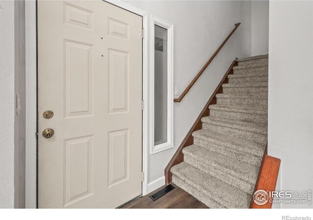 7414 Benton St, Arvada, CO 80003 - stairs featuring wood finished floors