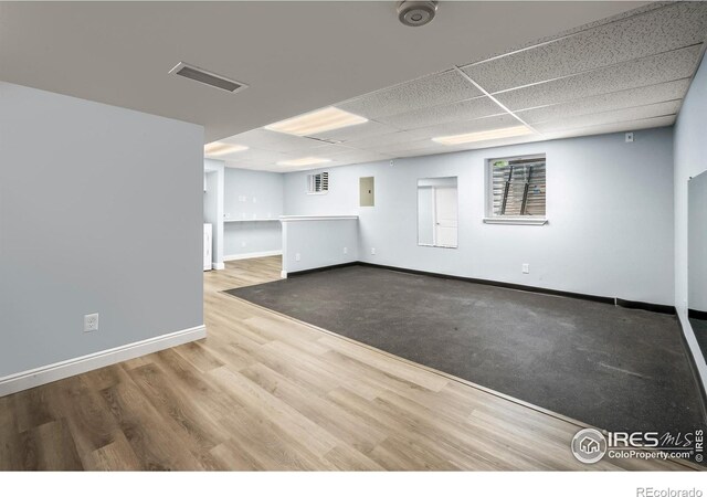 7414 Benton St, Arvada, CO 80003 - empty room featuring wood finished floors, electric panel, and a drop ceiling