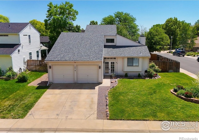 7414 Benton St, Arvada, CO 80003 - view of front facade with french doors, a shingled roof, concrete driveway, an attached garage, and a chimney