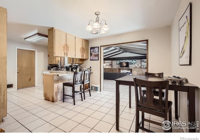 1036 Meadowbrook Dr, Fort Collins, CO 80521 - kitchen featuring light brown cabinets, a peninsula, light tile patterned floors, a chandelier, and light countertops